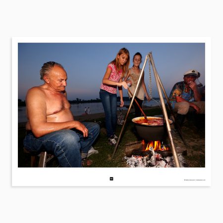 A family prepares fish soup on the beach of the Sava river. Šabac, Serbia, 2011.